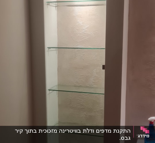 מדף זכוכית בתוך ארון מואר עם תאורה עליונה